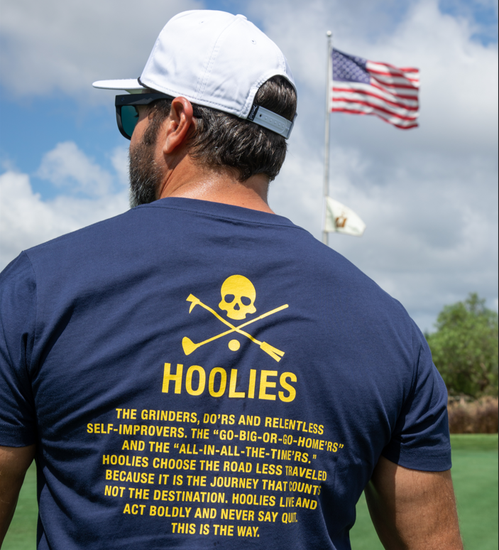 Golf T Shirt for Men in Navy with bold yellow creed text and Hoolie skull-and-crossbones design