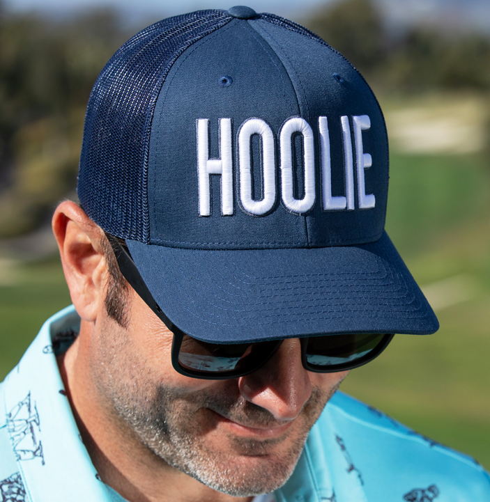 Men's Blue-White Hoolie Bold Golf Trucker Hat with blue 3D HOOLIE logo embroidery, rope accent, and mesh back.