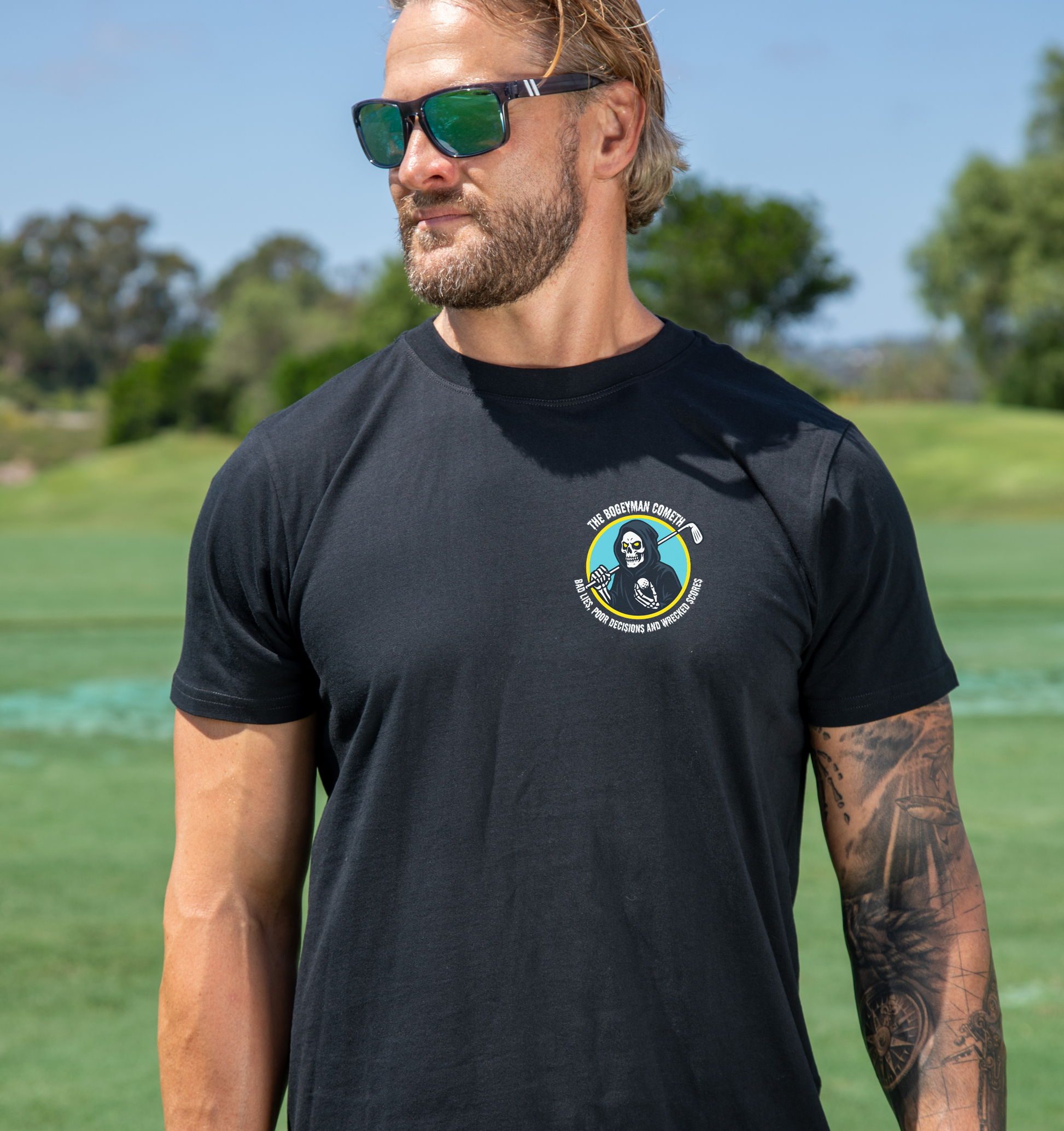 Men's Bogeyman Cometh Golf T Shirt in black with aqua and yellow reaper back graphic and chest logo.