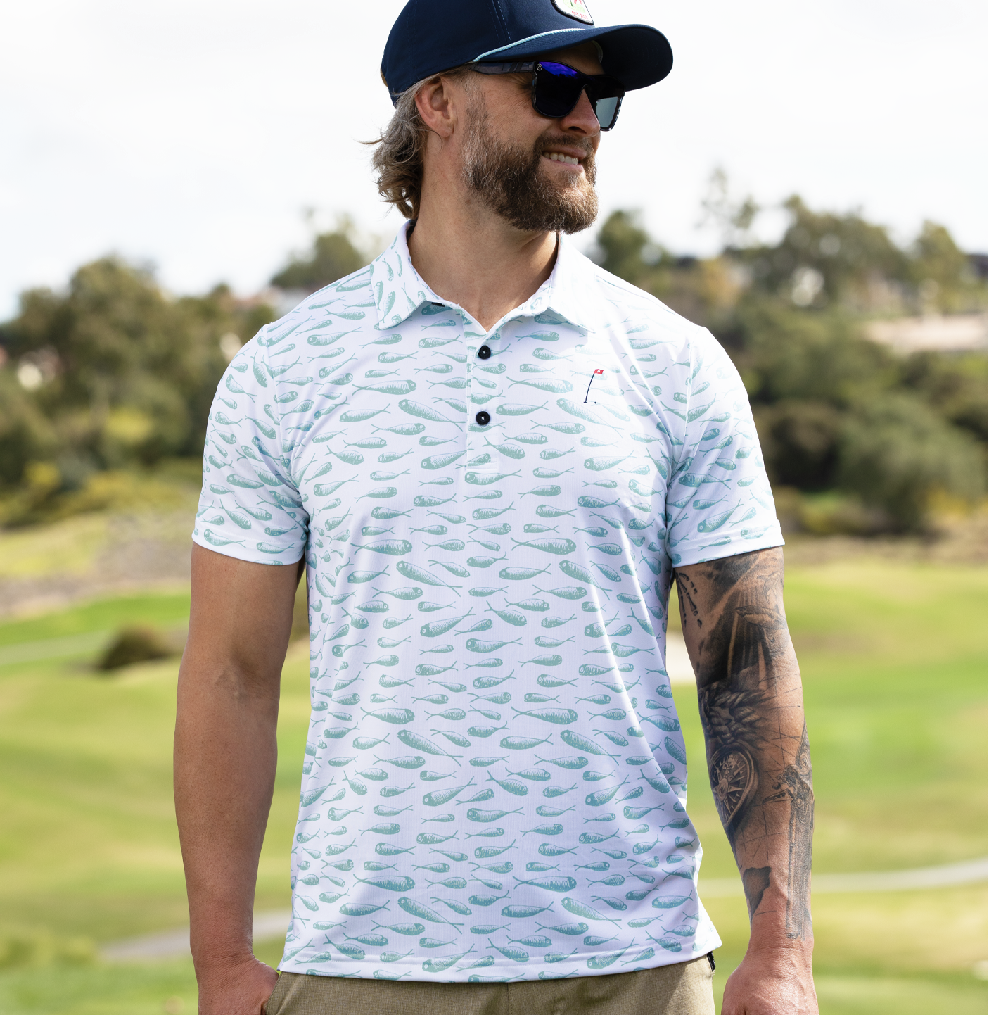 In the Drink Men's Golf Polo in White with aqua minnow pattern