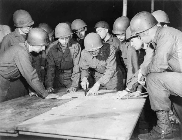 Military Leaders Look at Map Inspiration for Recce Polo