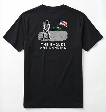 Back of Black T-shirt with astronaut putting a golf ball on the moon with earth seen behind him. Phrase on tee says The Eagles Are Landing.