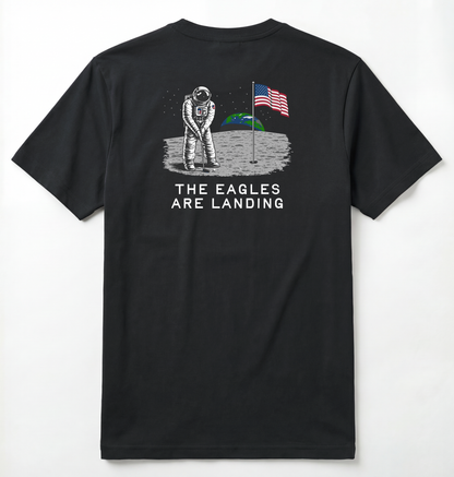 Back of Black T-shirt with astronaut putting a golf ball on the moon with earth seen behind him. Phrase on tee says The Eagles Are Landing.