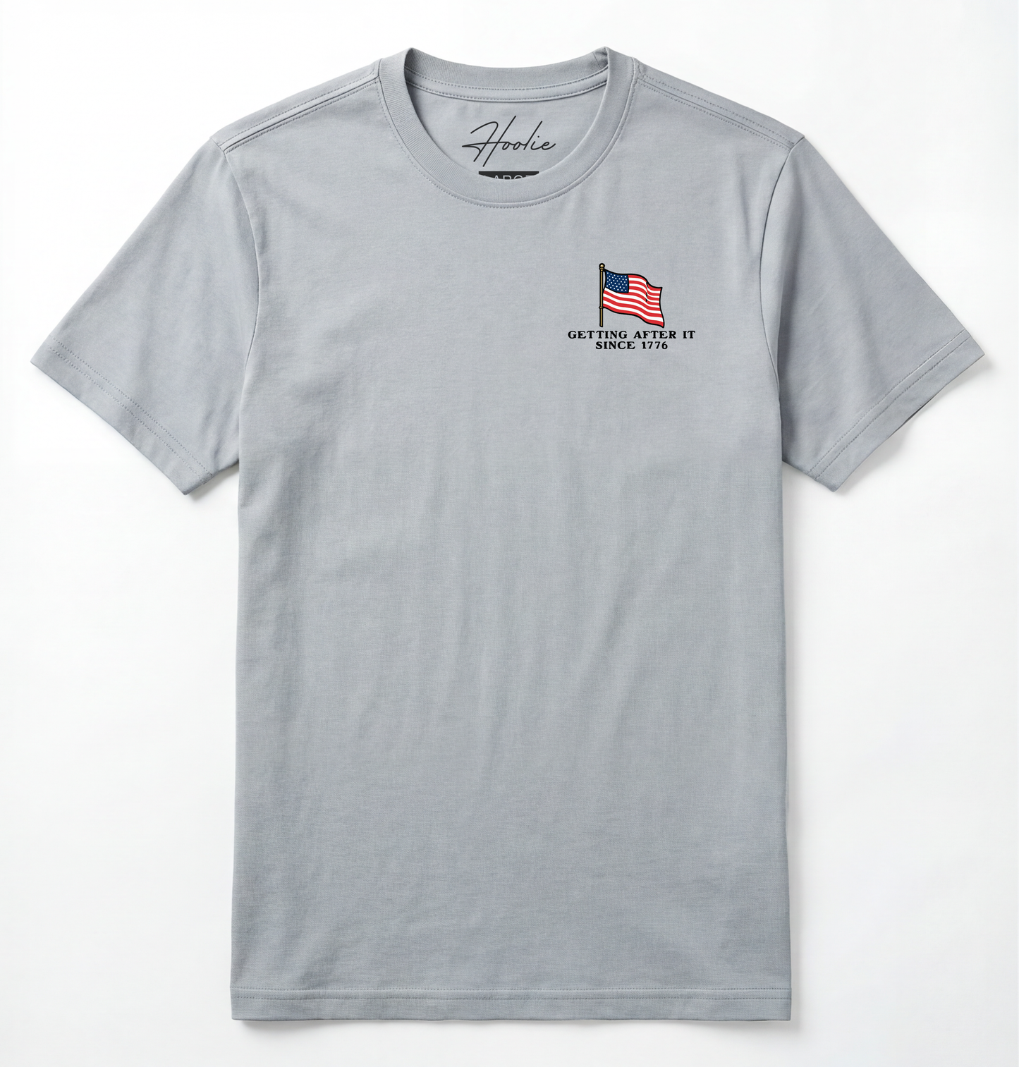 Front of Light gray T-shirt with American Flag that says Getting After it Since 1776