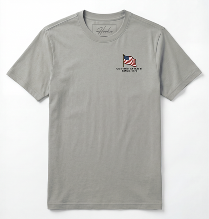 Front of Light gray T-shirt with American Flag that says Getting After it Since 1776