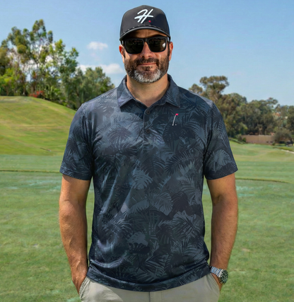 Man wearing Men's Performance Golf Polo with Various Shades of Blue and Gray Jungle Palm Fronds