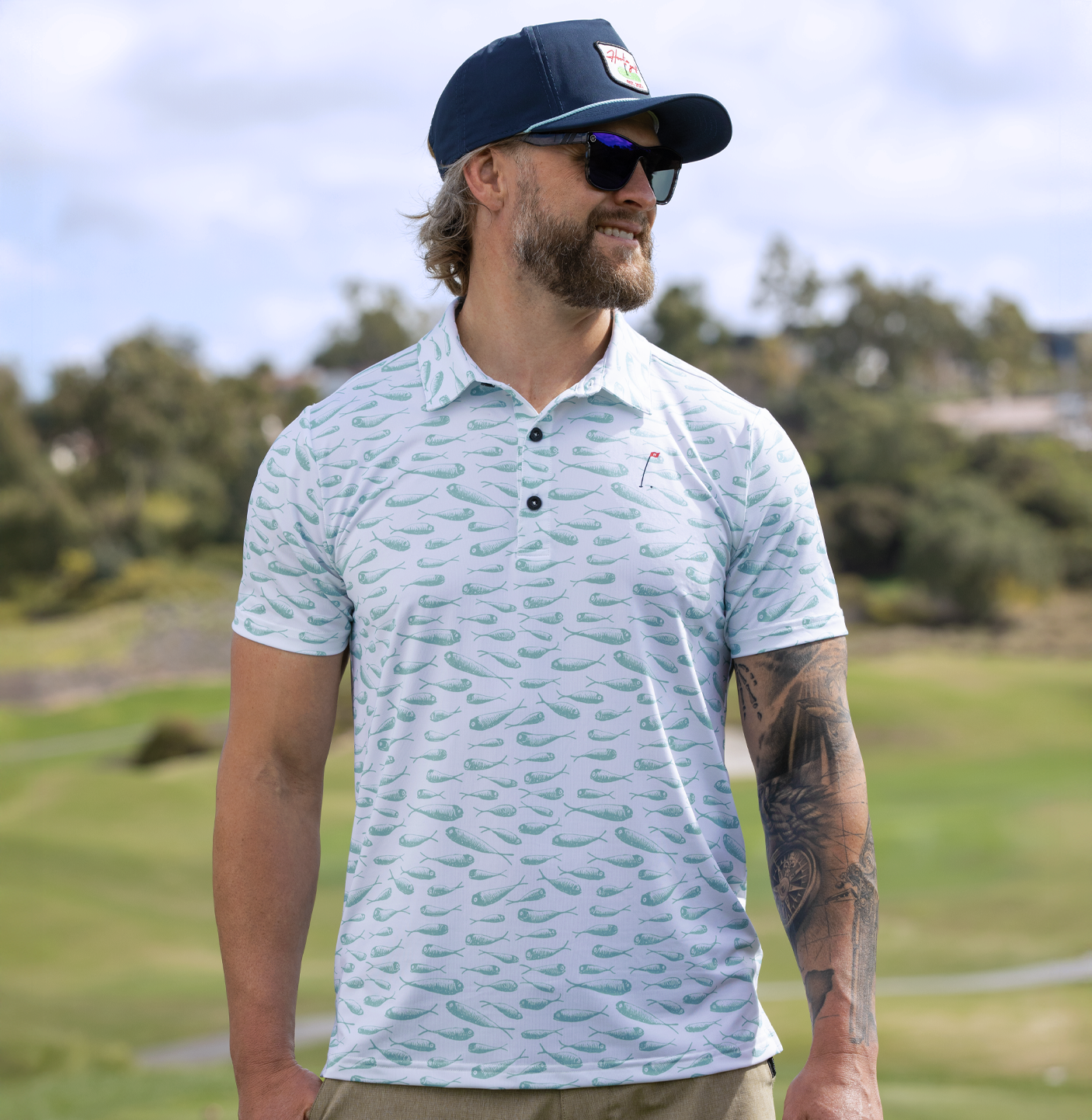 In the Drink Men's Golf Polo in White with aqua minnow pattern