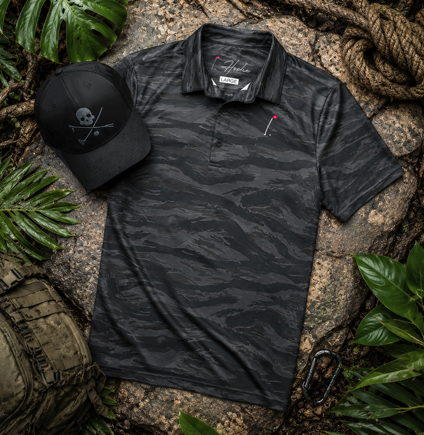 Black Tiger Stripe Polo and Black X Bones II Hat laying on jungle floor as part of the Operator's Bundle